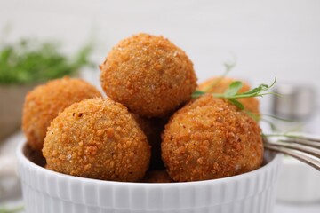 Bowl of delicious fried tofu balls with pea sprouts, closeup