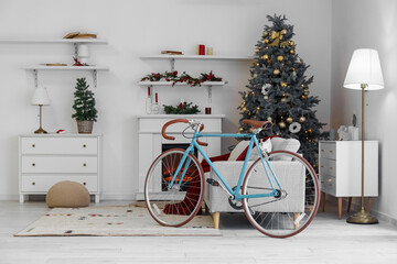 Obraz premium Interior of living room with bicycle, sofa and Christmas trees