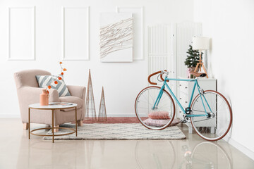 Obraz premium Interior of living room with bicycle, armchair and Christmas tree