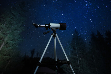 Modern telescope at night outdoors. Learning astronomy