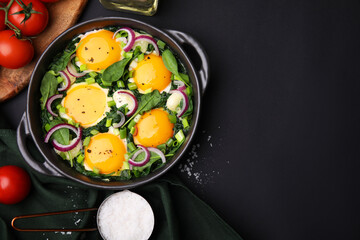 Flat lay composition with tasty Shakshouka and ingredients on black table. Space for text