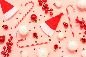 Composition with beautiful Christmas decorations and candy canes on pink background