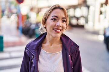 Young woman smiling confident looking to the side at street