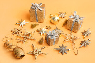 Beautiful Christmas decorations and gifts on color background