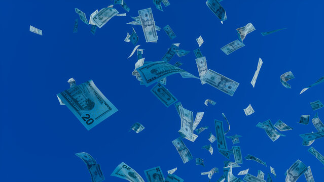 Cash falling from the Sky. Twenty Dollar Bills against Blue Sky backdrop. Wealth concept.