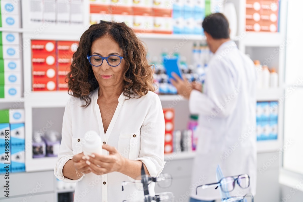 Sticker man and woman pharmacists using touchpad and client holding pills bottle at pharmacy