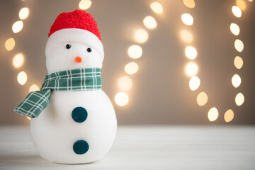 Snowman. Decoration for Christmas. White led lights bokeh on background. Home decor for Christmas...