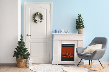 Interior of living room with white door, fireplace and Christmas trees