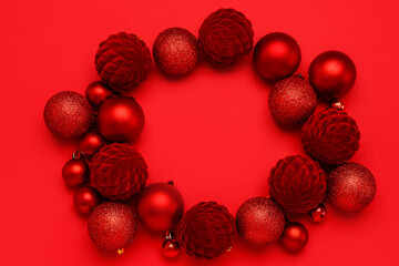Frame made of beautiful Christmas balls on red background