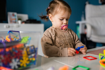 One child small caucasian girl toddler play at home alone