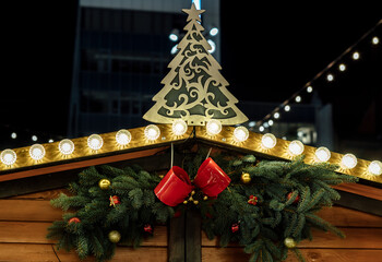 Lanterns with garlands at night. Traditional Christmas market decorations in the city. New Year celebration, holidays.	