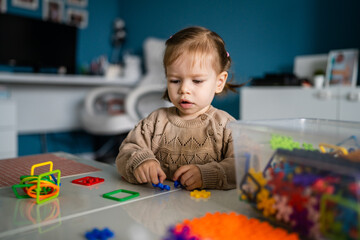 One child small caucasian girl toddler play at home alone