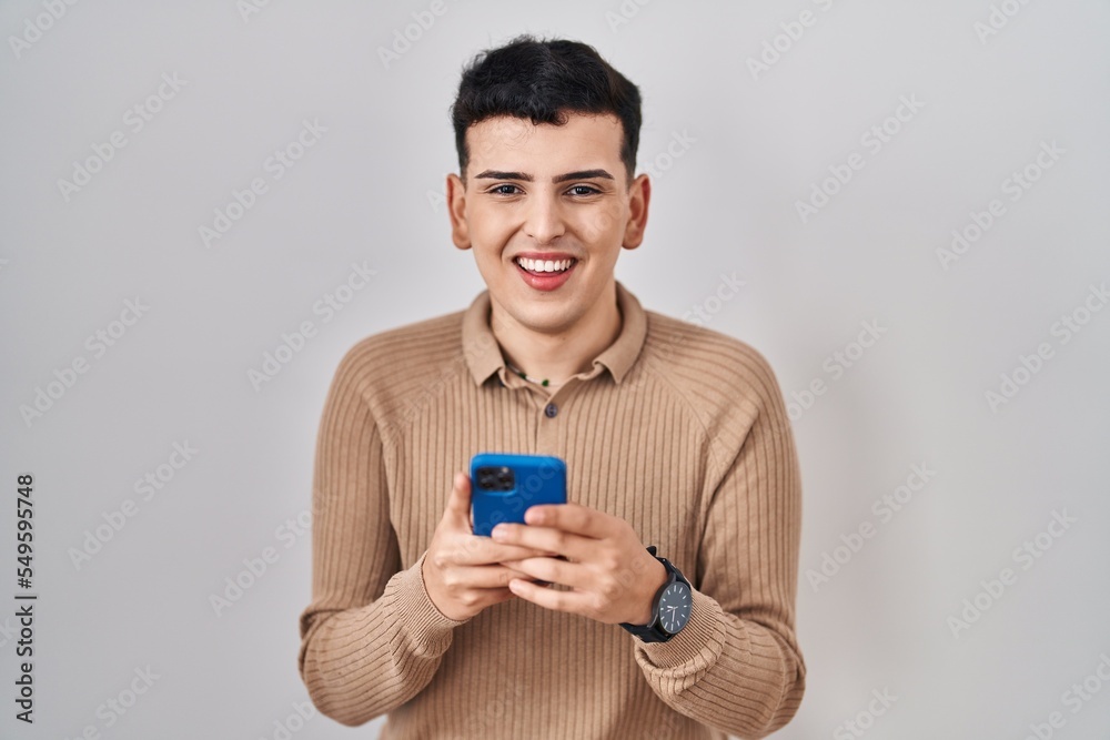 Sticker Non binary person using smartphone typing message smiling and laughing hard out loud because funny crazy joke.