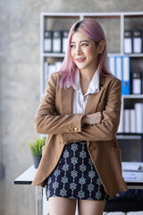 Image of young asian business women company worker in office, smiling and standing over office background