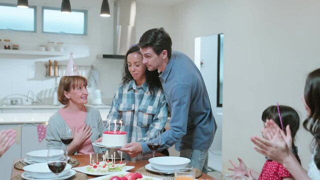 Multi-ethnic big family having a birthday party for young kid daughter