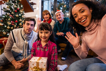 Multi-ethnic big family use mobile phone video call online to relative