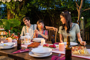 Multi-ethnic big family having fun, enjoy party outdoors in the garden. 