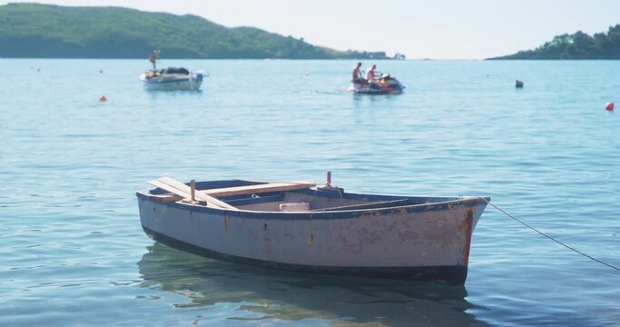 Tourist rowing boat rocks on light waves near beach against sea bay. Excited resting travellers enjoy time sailing on catamaran in tropical resort city