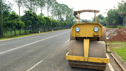 Heavy roller constructing a road at a new estate.