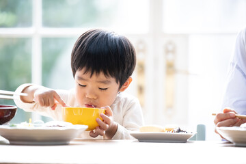 Close-up of cute Asian toddler eating 