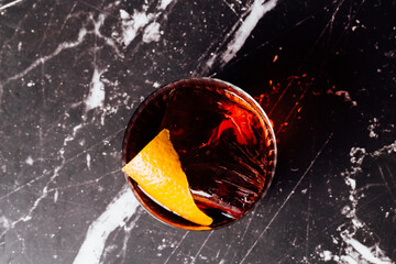 negroni cocktail glass aperitif top view on a marble table with a black background