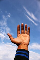 Empty hand showing something hope, something isolated on sky and clouds background