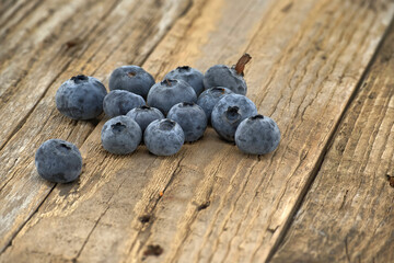 Fresh blueberries on rustic wooden background