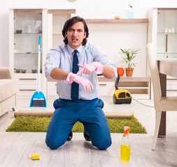 Young businessman cleaning the house