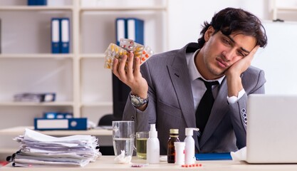 Man with flu working in the office