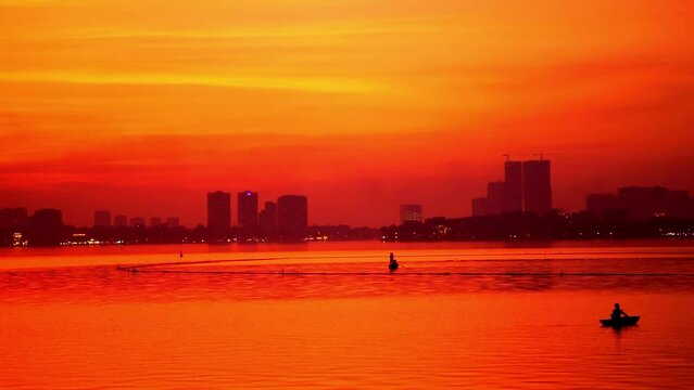 Red Fire Orange Sunset Skies Over Tay Ho Lake In Hanoi. Pan Right