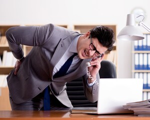 Businessman feeling pain in the office