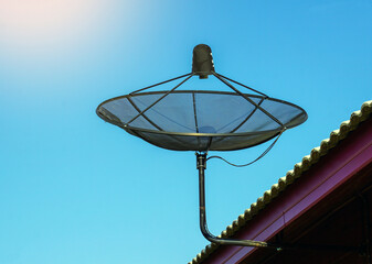 Satellite dish installed on the roof of the house for receiving television waves. Soft and selective focus.