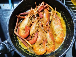 Prawns curry served in a pan. Selective focus.