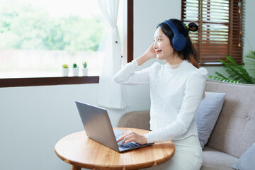 Portrait of a beautiful Asian teenage girl using a computer