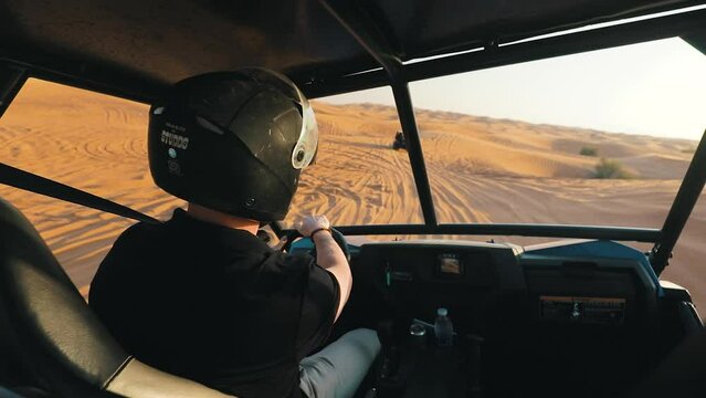 Man Driving A Buggy In The Desert Sand, Off road on Dunes, Dubai