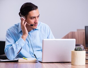 Call center operator working at his desk