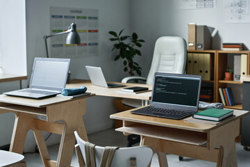Modern empty class with desks and computers for studying information technology