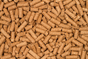 Texture from cat litter granules. Brown granules close-up.