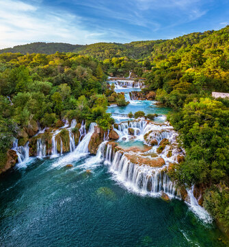 Krka, Croatia - Aerial view of the beautiful Krka Waterfalls in Krka National Park on a bright summer morning with green foliage, turquoise water and blue sky