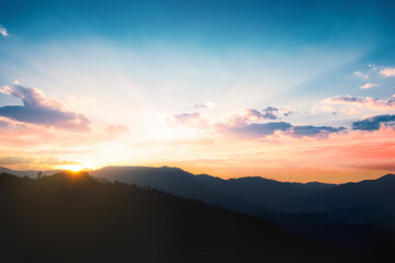 Panoramic mountains and dramatic sky sunrise background
