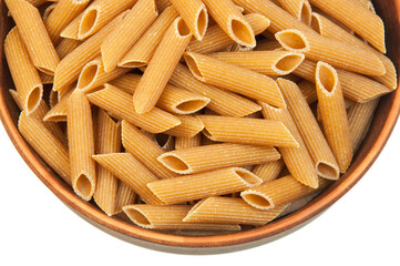 pasta in a clay bowl on a white background. durum noodles on a light texture. italian penne in a brown bowl on a white surface