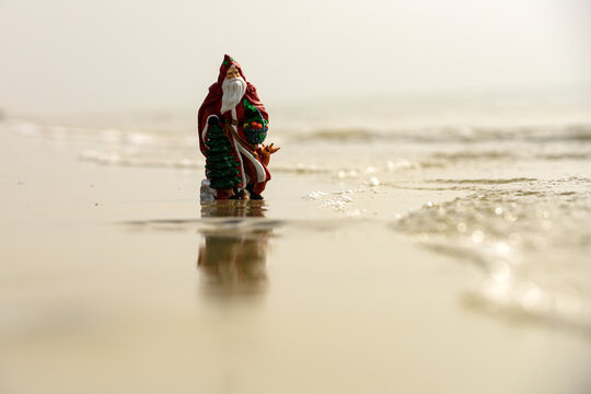 Summer Santa on sand. Holiday concept. Christmas greeting cards design.