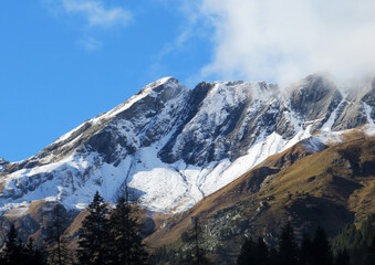 Fototapeta na wymiar The first autumn snow on the Alpine peak Älplichopf (2641 m) in the Swiss Alps and in the UNESCO World Heritage Tectonic Arena Sardona (UNESCO-Welterbe Tektonikarena Sardona), Vättis - Switzerland