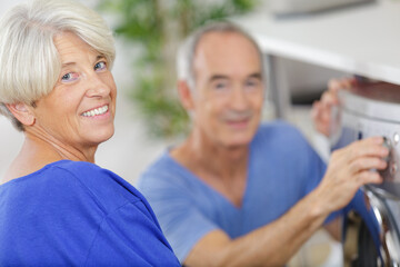 old couple in store choosing washing machine