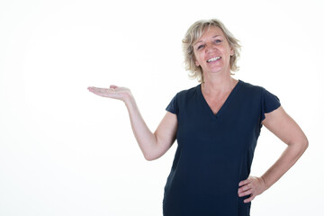 smiling blonde woman senior showing up palm an empty side hand white blank copy space