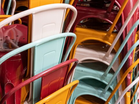 steel stack of multicolored industrial chairs Metal