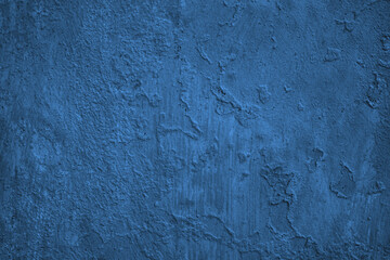 Blue old painted rough wall surface. Dark abstract background with space for design. Grunge.