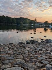 incredible sunset view on the lake and stones background