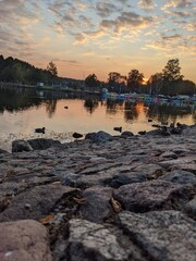 incredible sunset view on the lake and stones background