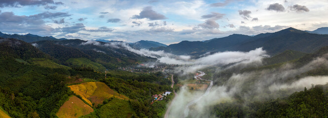 High angle panorama taken by drone. View of Bo Kluea District, Nan Province. Morning fog in a...